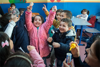 Celebrating girl with a group of kids in an education center in Istanbul.