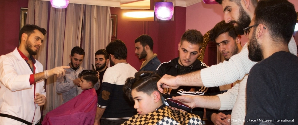 Young people receiving hairdressing training.