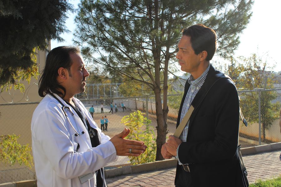 Sid Johann Peruvemba (right), in conversation with a doctor at the Malteser International field hospital in Kilis, Turkey.