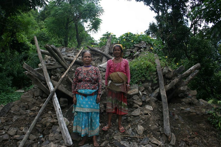 Latima and her sister in the ruins of their old home.