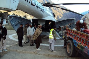 Down in the valley the helicopter is loaded to bring to the winter relief up to the high mountains. Photo: Malteser International